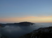 Another hill just poking above the cloud