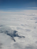 Mountains poke through the clouds