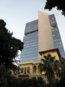 A new building towers above an older one